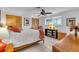 Cozy bedroom featuring a ceiling fan, shuttered closet, and a bright, sunlit window at 491 Conrad Rd, Venice, FL 34293