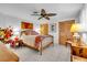 Comfortable bedroom showcasing a wooden bed frame, ceiling fan, and charming decorations at 491 Conrad Rd, Venice, FL 34293