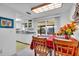 Bright dining area with sliding glass doors and a view of the lanai and updated kitchen area at 491 Conrad Rd, Venice, FL 34293