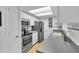 Bright kitchen featuring white cabinets, stainless steel appliances, and plenty of counter space at 491 Conrad Rd, Venice, FL 34293