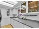 Updated kitchen features white cabinets, stainless steel appliances and modern countertops at 491 Conrad Rd, Venice, FL 34293