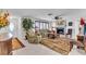 Comfortable living room with a fireplace, ceiling fan, tile flooring, and ample natural light at 491 Conrad Rd, Venice, FL 34293