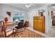 Bright office space featuring a ceiling fan, a large desk, and a vintage wood dresser at 491 Conrad Rd, Venice, FL 34293