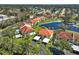 Beautiful aerial view of villas with red roofs surrounding a scenic pond in a lush community at 503 Pine Hollow Cir # 503, Englewood, FL 34223