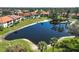 Aerial view of the community featuring a tranquil pond, lush landscaping, and well-maintained grounds and buildings at 503 Pine Hollow Cir # 503, Englewood, FL 34223