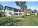 The home features a well-maintained lawn and mature landscaping offering privacy and shade to the property at 503 Pine Hollow Cir # 503, Englewood, FL 34223