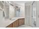 Bathroom featuring a large mirror, a wooden vanity and a toilet in a separate area at 503 Pine Hollow Cir # 503, Englewood, FL 34223
