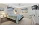 Comfortable bedroom featuring a ceiling fan, two windows, and a blue patterned bedspread at 503 Pine Hollow Cir # 503, Englewood, FL 34223