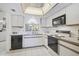 Well-maintained kitchen with modern appliances, white cabinets, and lots of counter space at 503 Pine Hollow Cir # 503, Englewood, FL 34223