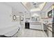 Functional kitchen with white cabinets, black appliances, and an adjacent dining area for convenience at 503 Pine Hollow Cir # 503, Englewood, FL 34223