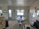 Cozy dining area features a white table, chairs and a chandelier hanging above at 519 Roma Rd, Venice, FL 34285