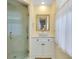 Well-lit bathroom features a tiled shower, glass doors, and modern sink at 521 Circlewood Dr # Q11, Venice, FL 34293