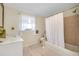 Bathroom with tiled floors, shower, and modern sink at 521 Circlewood Dr # Q11, Venice, FL 34293