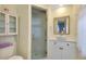 Bathroom featuring glass shower doors, tiled shower, and a modern sink at 521 Circlewood Dr # Q11, Venice, FL 34293