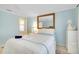 Bedroom featuring neutral decor, carpet, and a large decorative mirror at 521 Circlewood Dr # Q11, Venice, FL 34293