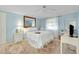 Comfortable bedroom featuring carpet, ceiling fan, and a well-lit vanity area at 521 Circlewood Dr # Q11, Venice, FL 34293