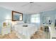 Light blue bedroom featuring a ceiling fan, carpet, and a decorative mirror at 521 Circlewood Dr # Q11, Venice, FL 34293