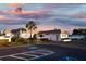 Exterior shot of the community clubhouse with American flag at dusk at 521 Circlewood Dr # Q11, Venice, FL 34293