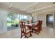 Dining room featuring a chandelier, large windows, and seating for six at 521 Circlewood Dr # Q11, Venice, FL 34293