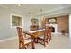 Dining area with brick wall detail, a fireplace, and view into the kitchen at 521 Circlewood Dr # Q11, Venice, FL 34293
