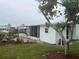 Side yard view of home featuring mature trees and landscaping at 524 S Cervina Dr, Venice, FL 34285