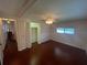 Bedroom with ceiling fan, hardwood floors, bi-fold closet and view to hallway at 524 S Cervina Dr, Venice, FL 34285