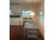 Bright dining area with white cabinets and a vintage hanging light at 524 S Cervina Dr, Venice, FL 34285