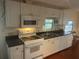 Well-equipped kitchen with stainless steel sink, microwave, and stove top at 524 S Cervina Dr, Venice, FL 34285