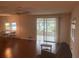 Living room with wood floors, ceiling fan, and access to a screen room at 524 S Cervina Dr, Venice, FL 34285