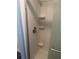 Clean white shower showcasing a chrome showerhead and built-in shelving at 524 S Cervina Dr, Venice, FL 34285