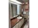 This cozy bathroom features a single sink vanity, wall storage, and is well lit at 532 Via Veneto, Venice, FL 34285