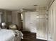 Bedroom with white wood paneling, closet, and ceiling fan and adjoined with a bathroom at 532 Via Veneto, Venice, FL 34285