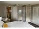 Bedroom featuring a white comforter, ceiling fan, closet and is adjoined with a bathroom at 532 Via Veneto, Venice, FL 34285