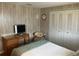 A neutral bedroom with a double bed, wood-look floors, and a large closet at 532 Via Veneto, Venice, FL 34285