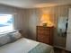 This bedroom boasts a closet, wood-look floors, and a dresser at 532 Via Veneto, Venice, FL 34285