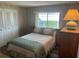 A cozy bedroom with a double bed, wood-look floors, and a large window at 532 Via Veneto, Venice, FL 34285