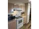 Bright kitchen with white appliances and wood-look floors at 532 Via Veneto, Venice, FL 34285