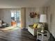 Comfortable living room area featuring a sofa, side table, and a view to an enclosed patio at 532 Via Veneto, Venice, FL 34285