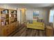 A sitting room with wood-look floors, neutral walls, and a built in bookcase at 532 Via Veneto, Venice, FL 34285
