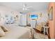 Cozy bedroom featuring a ceiling fan, wood flooring, and calming decor elements at 5635 Golf Pointe Dr # 105, Sarasota, FL 34243