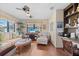 Inviting living room featuring comfortable seating, a ceiling fan, and a large window showcasing the view at 5635 Golf Pointe Dr # 105, Sarasota, FL 34243