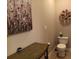 Cozy powder room with decorative accents, a floral wreath, and a vanity, creating a welcoming and functional space at 601 Club House Rd, Venice, FL 34285