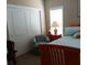 Comfortable bedroom featuring a bed, nightstand, closet, and window, creating a serene and inviting space at 601 Club House Rd, Venice, FL 34285