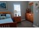 Comfortable bedroom with a wood bed frame, light blue bedding, and matching wood nightstand and dresser at 601 Club House Rd, Venice, FL 34285