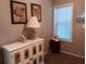 Cozy bedroom with a decorative cabinet, lamp, and window, offering a peaceful retreat at 601 Club House Rd, Venice, FL 34285