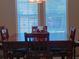 Dining room boasting a wooden dining table and chairs illuminated by a chandelier, showcasing a cozy dining space at 601 Club House Rd, Venice, FL 34285