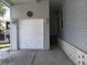Attached garage featuring a classic white door and decorative outdoor lighting at 601 Club House Rd, Venice, FL 34285