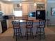Bright kitchen with a central island, pendant lighting, and modern appliances at 601 Club House Rd, Venice, FL 34285