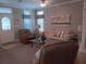 Inviting living room featuring a comfortable sofa, recliner, glass table, and decorative painting, creating a welcoming space at 601 Club House Rd, Venice, FL 34285