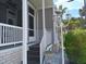 Inviting front porch with decorative white railing and lantern-style lighting at 601 Club House Rd, Venice, FL 34285